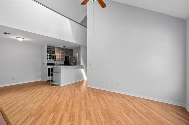 a view of a kitchen with wooden floor and a kitchen