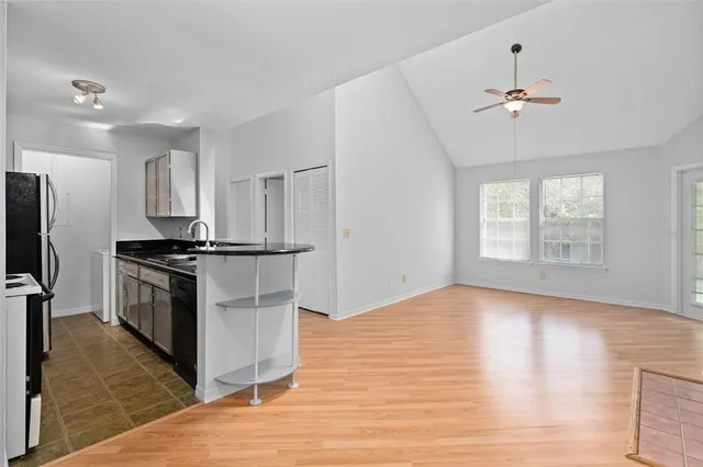 a kitchen with a refrigerator and a stove top oven