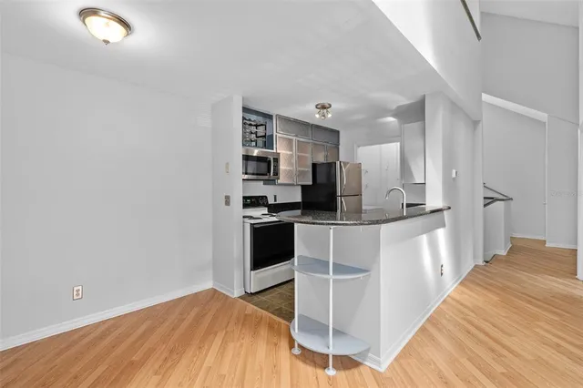 a kitchen with stainless steel appliances a refrigerator and microwave