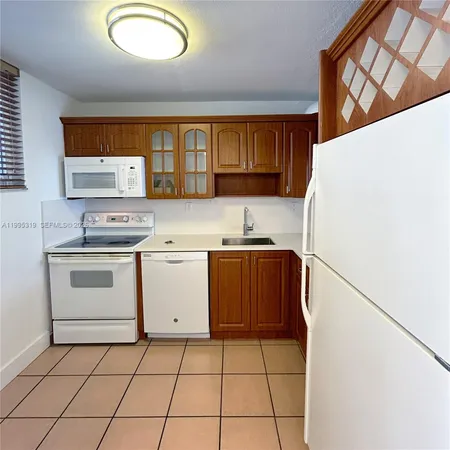 a kitchen with a stove a sink and a refrigerator
