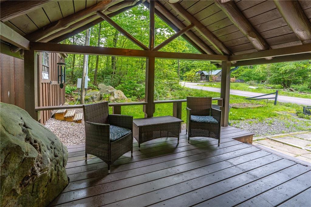 124 New Beaver Creek Road Markleysburg, PA 15459 - Photo 7 of 31 a view of a deck with chairs and wooden floor