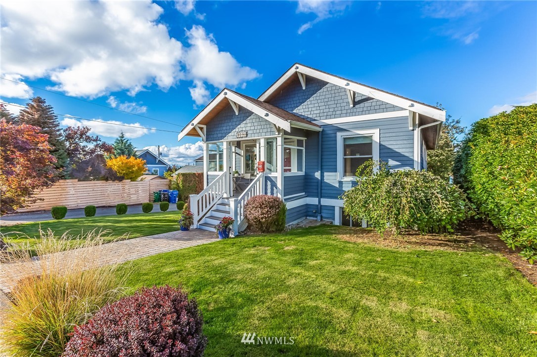 4140 Southwest Ida Street Seattle, WA 98136 - Photo 2 of 39 a front view of a house with a yard table and chairs