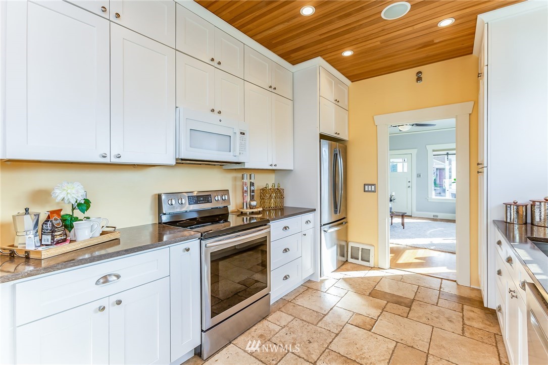 4140 Southwest Ida Street Seattle, WA 98136 - Photo 12 of 39 a kitchen with stainless steel appliances granite countertop a refrigerator and cabinets