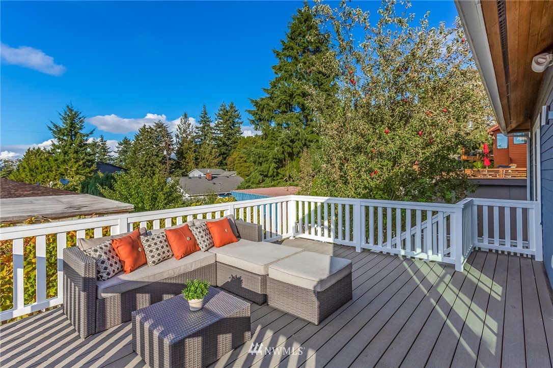 4140 Southwest Ida Street Seattle, WA 98136 - Photo 18 of 39 a balcony with wooden floor and outdoor seating