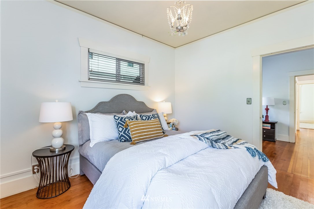 4140 Southwest Ida Street Seattle, WA 98136 - Photo 22 of 39 a bedroom with a bed and wooden floor