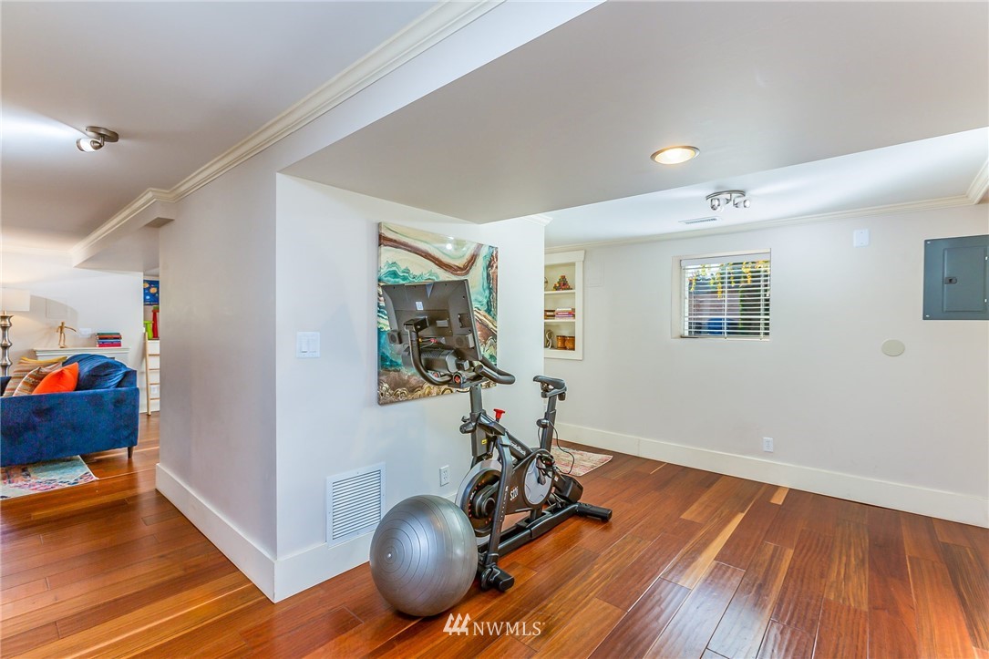 4140 Southwest Ida Street Seattle, WA 98136 - Photo 28 of 39 a view of a room with wooden floor and gym equipment