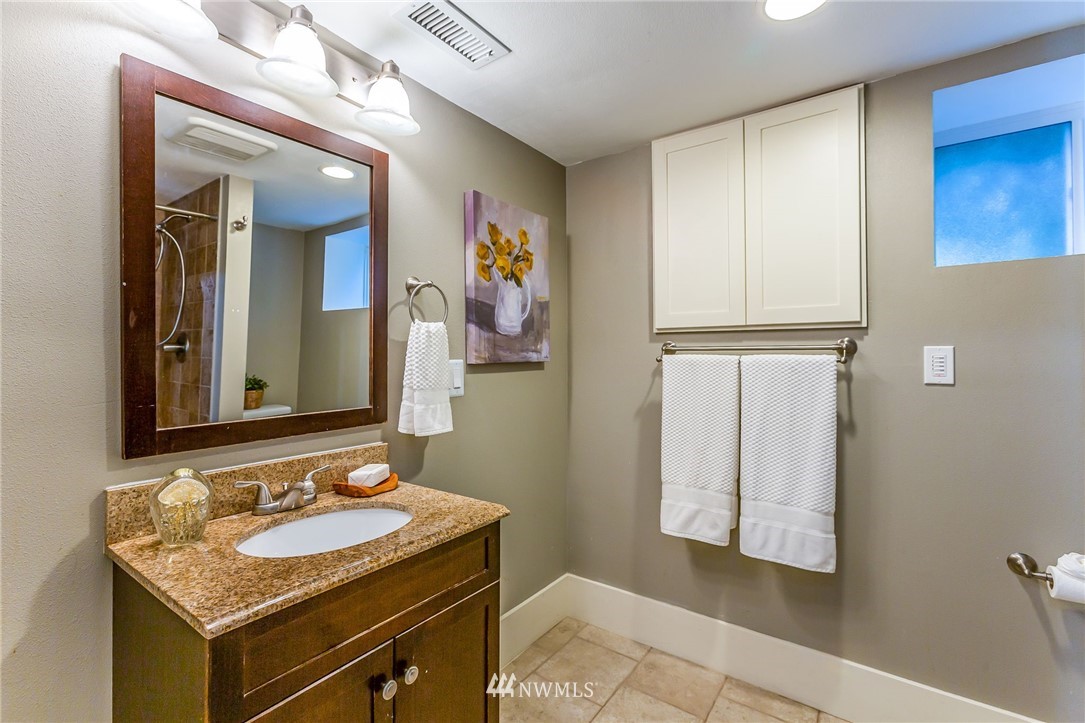 4140 Southwest Ida Street Seattle, WA 98136 - Photo 34 of 39 a bathroom with a granite countertop sink and a mirror