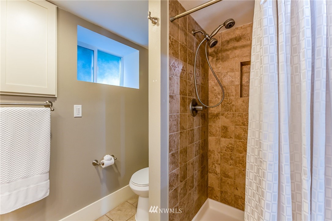 4140 Southwest Ida Street Seattle, WA 98136 - Photo 35 of 39 a bathroom with a granite countertop shower and a toilet