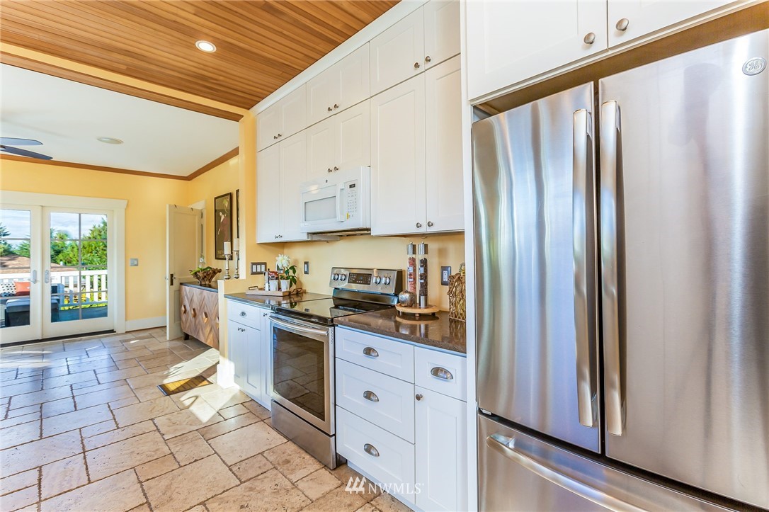 4140 Southwest Ida Street Seattle, WA 98136 - Photo 9 of 39 a kitchen with stainless steel appliances granite countertop a refrigerator and a stove