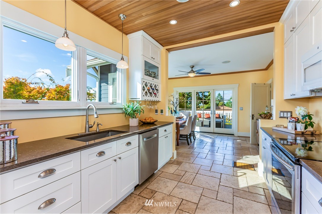 4140 Southwest Ida Street Seattle, WA 98136 - Photo 10 of 39 a large kitchen with stainless steel appliances granite countertop a lot of counter space and a sink