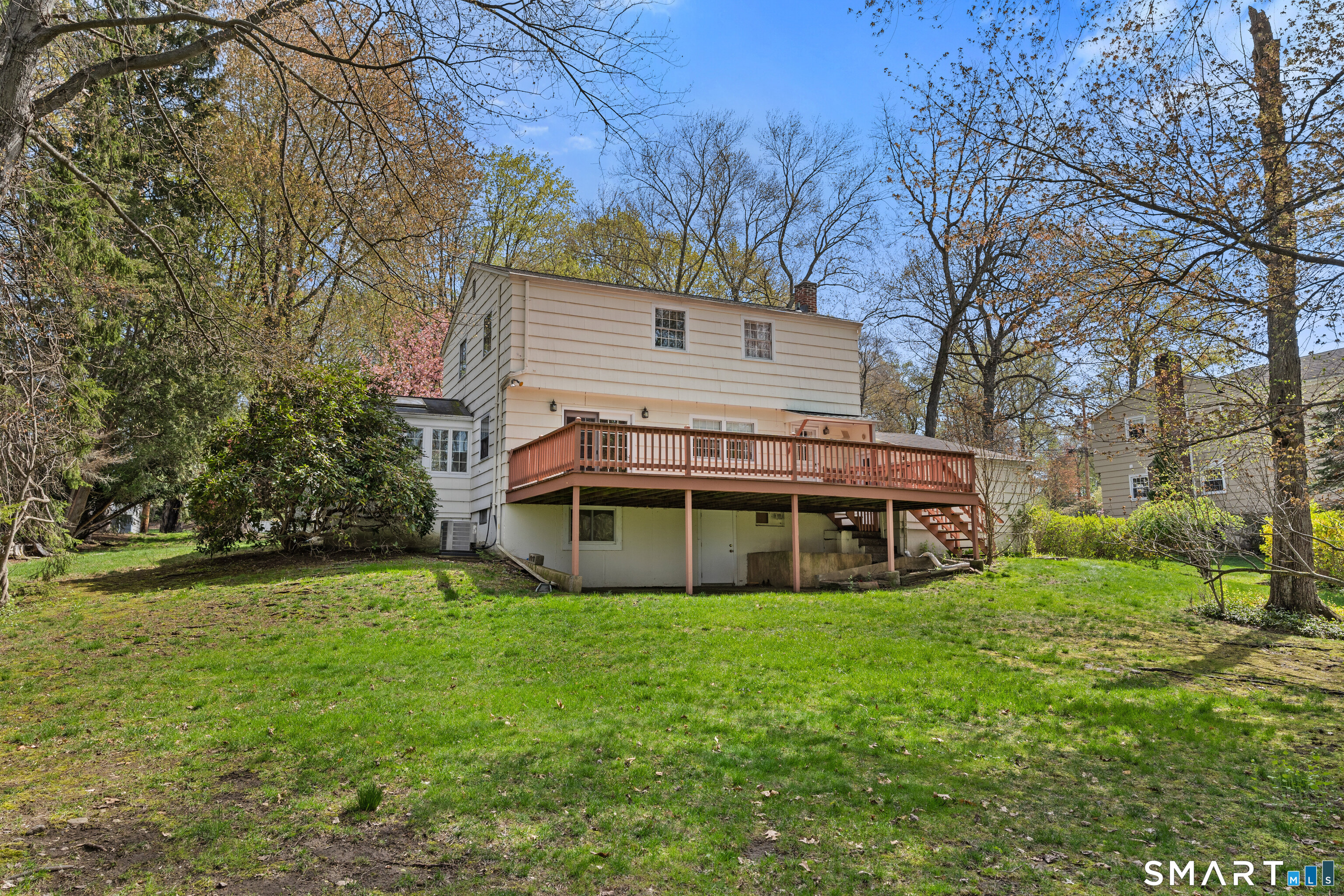 251 Shelter Rock Road Fairfield, CT 06825 - Photo 36 of 38 a view of a house with a big yard and large trees
