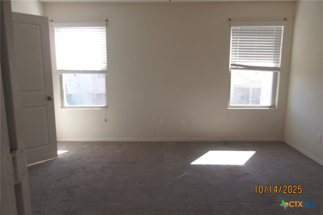 117 Open Sky Way, Unit 4D Jarrell, TX 76537 - Photo 20 of 36 an empty room with a window
