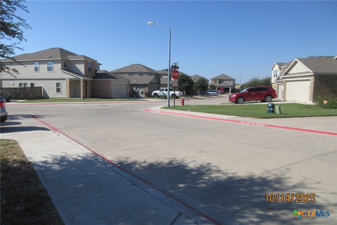117 Open Sky Way, Unit 4D Jarrell, TX 76537 - Photo 2 of 36 a view of a street with cars on the road