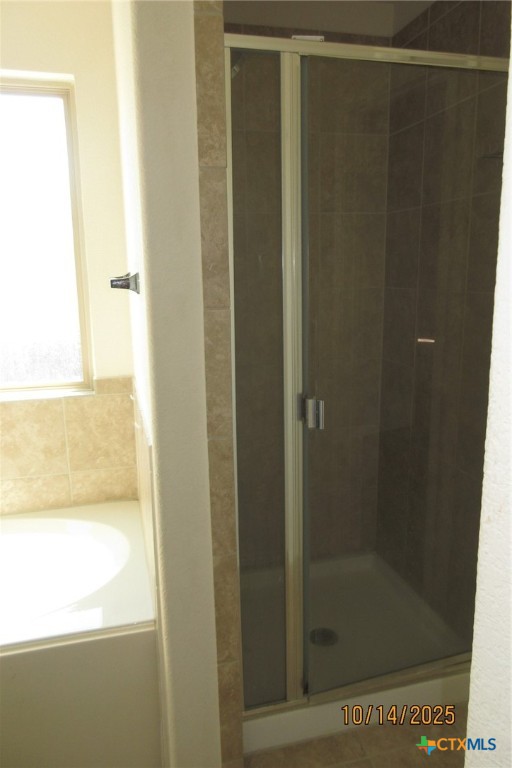 117 Open Sky Way, Unit 4D Jarrell, TX 76537 - Photo 26 of 36 a bathroom with a glass shower door