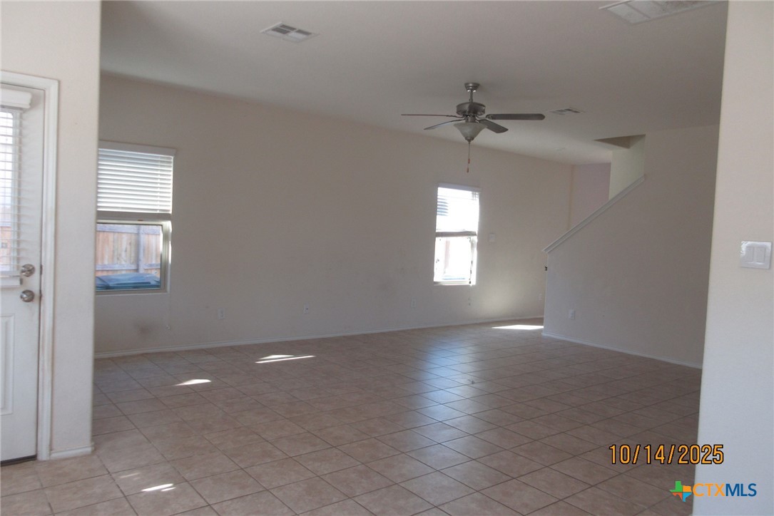 117 Open Sky Way, Unit 4D Jarrell, TX 76537 - Photo 10 of 36 wooden floor in an empty room with a window
