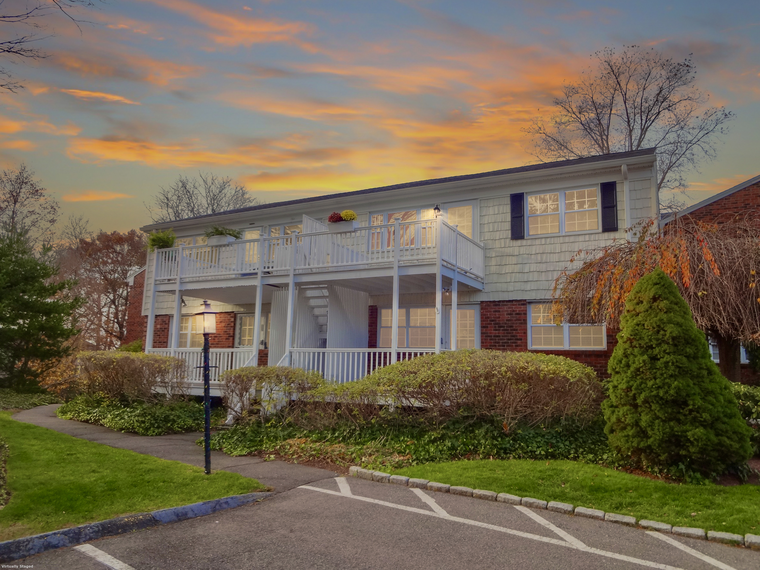 245 Unquowa Road, Unit 34 Fairfield, CT 06824 - Photo 1 of 24 a view of a brick house next to a yard with potted plants