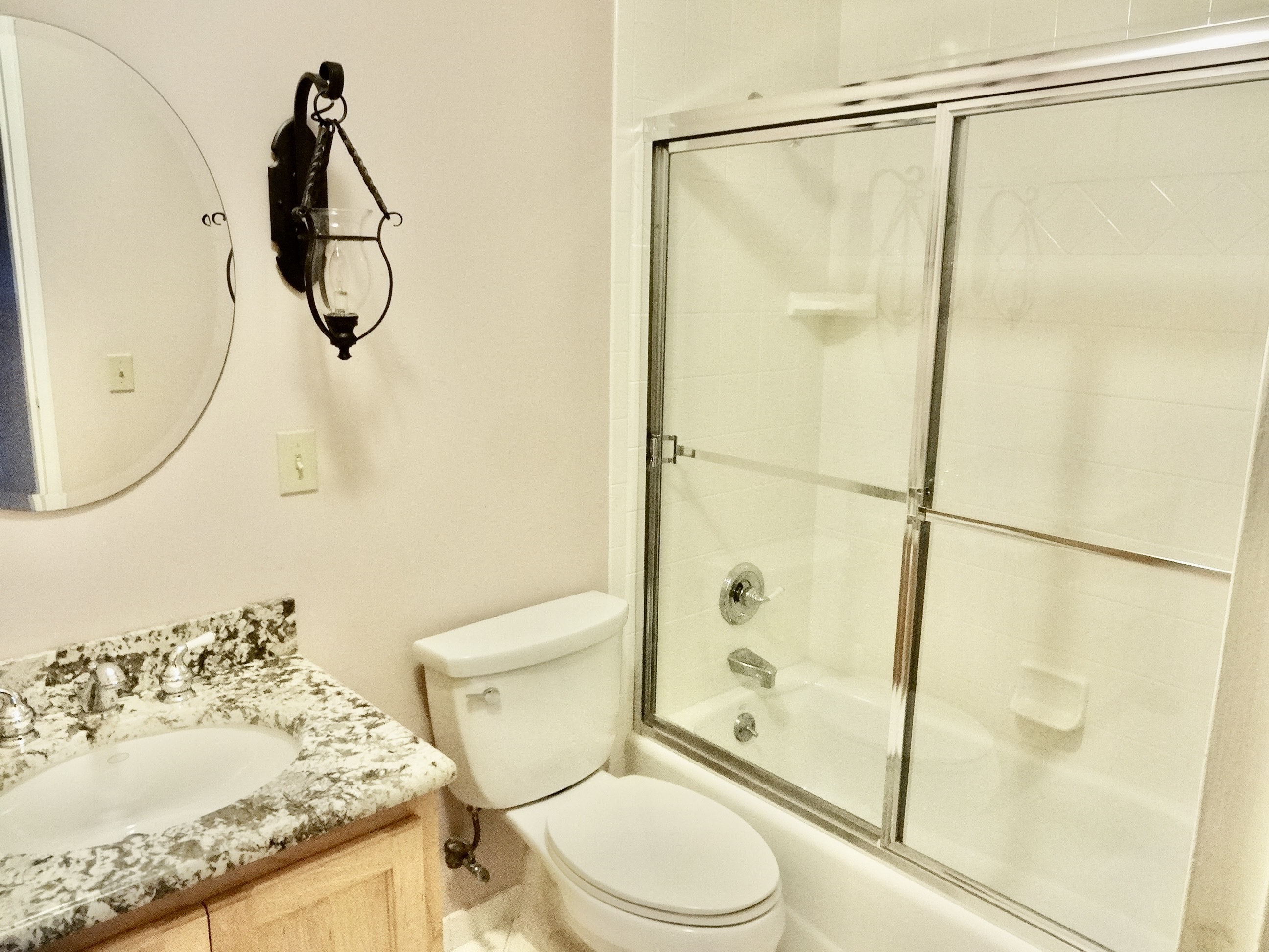 245 Unquowa Road, Unit 34 Fairfield, CT 06824 - Photo 11 of 24 a bathroom with a granite countertop sink toilet and shower