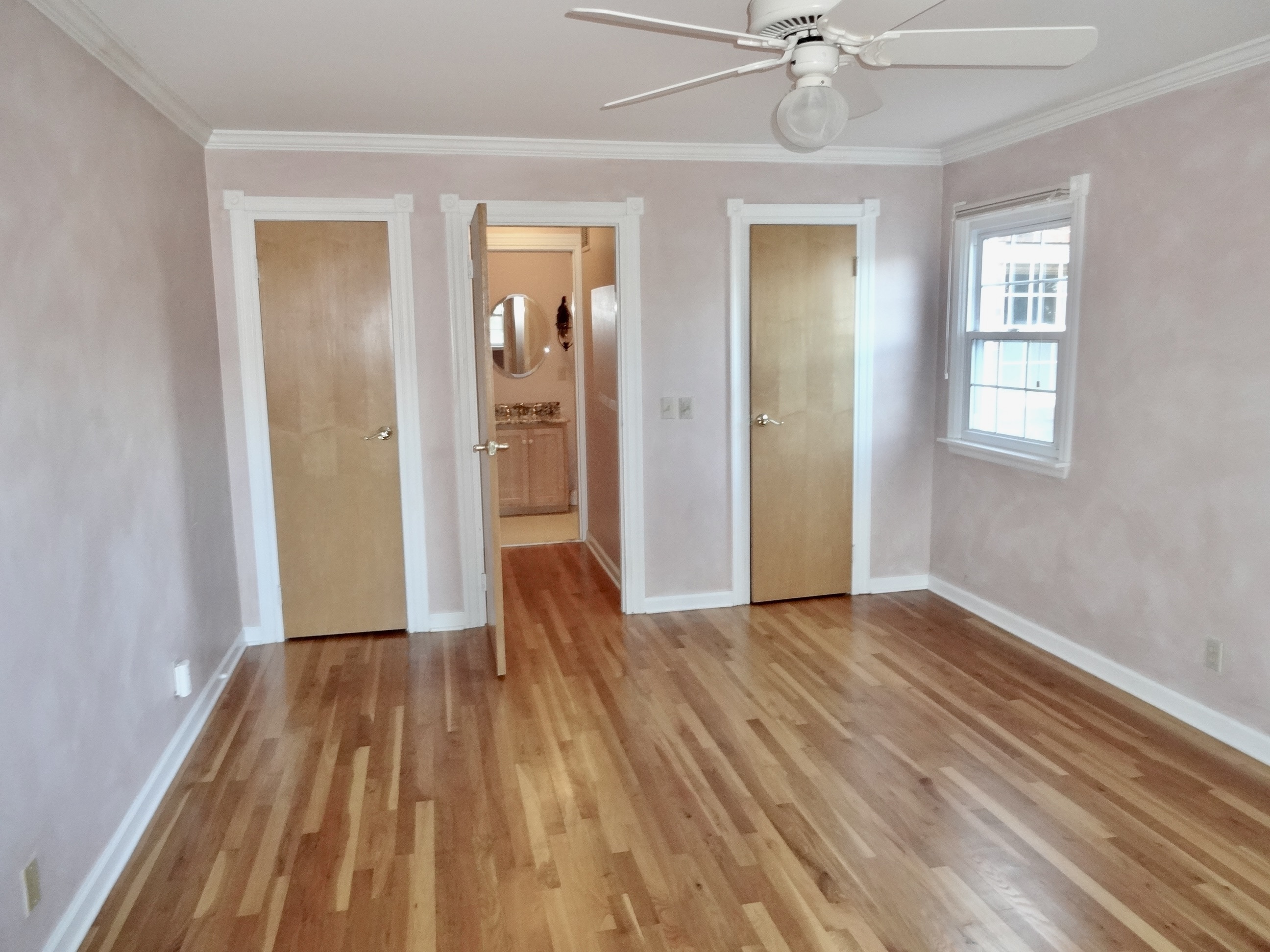 245 Unquowa Road, Unit 34 Fairfield, CT 06824 - Photo 20 of 24 a view of a livingroom with wooden floor and a ceiling fan