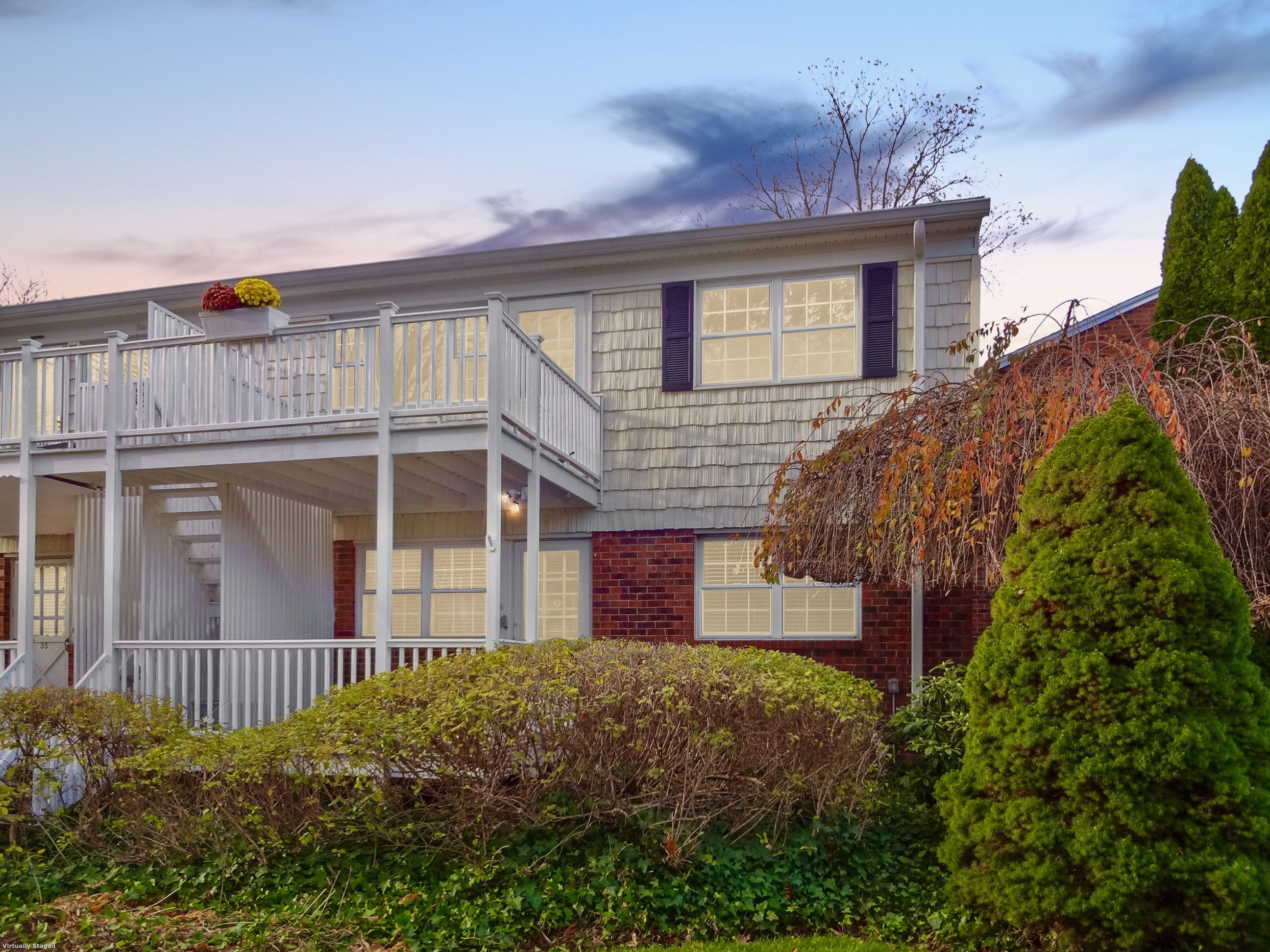 245 Unquowa Road, Unit 34 Fairfield, CT 06824 - Photo 2 of 24 a front view of a house with a yard