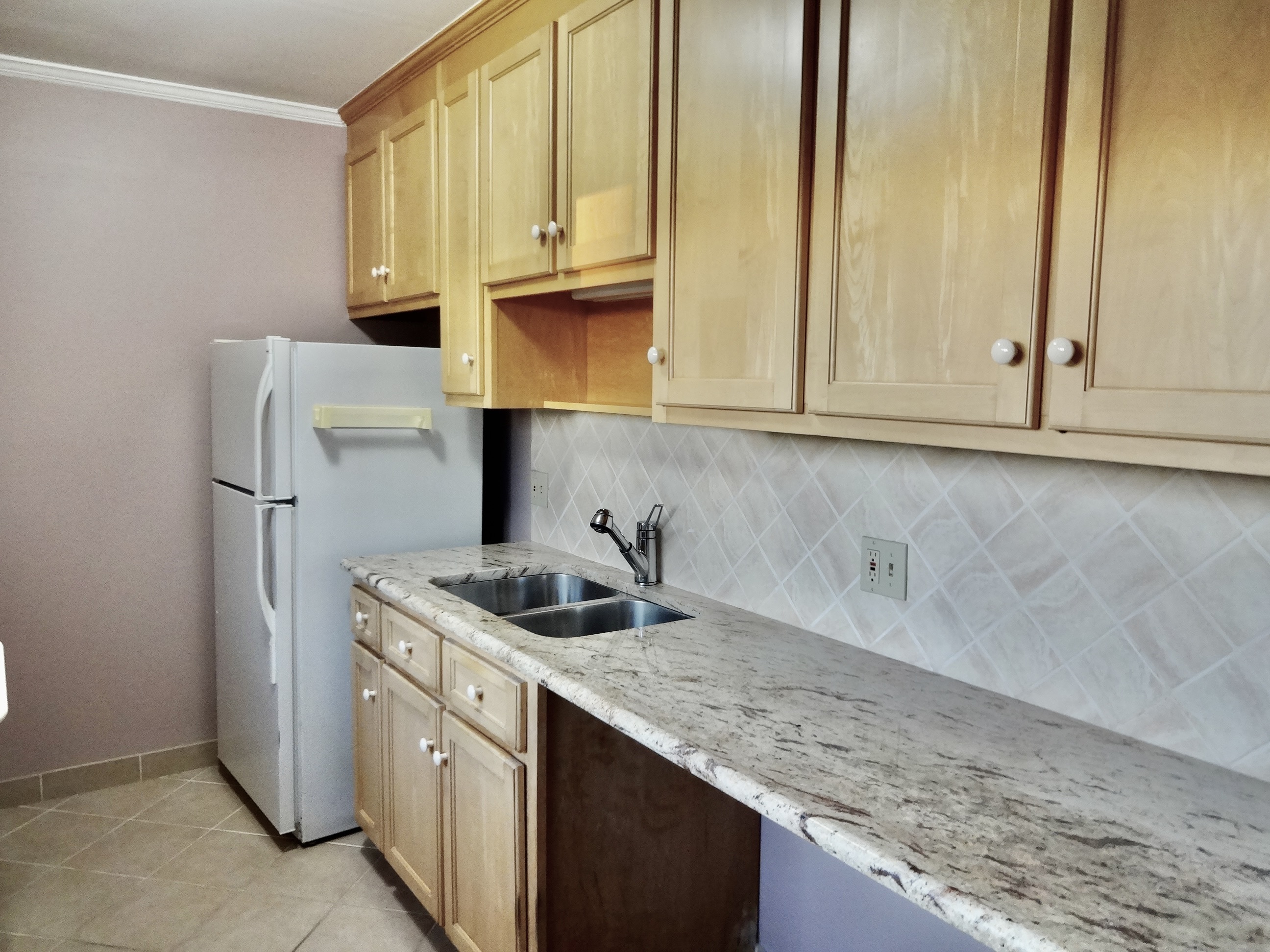245 Unquowa Road, Unit 34 Fairfield, CT 06824 - Photo 7 of 24 a kitchen with stainless steel appliances granite countertop white cabinets and a sink