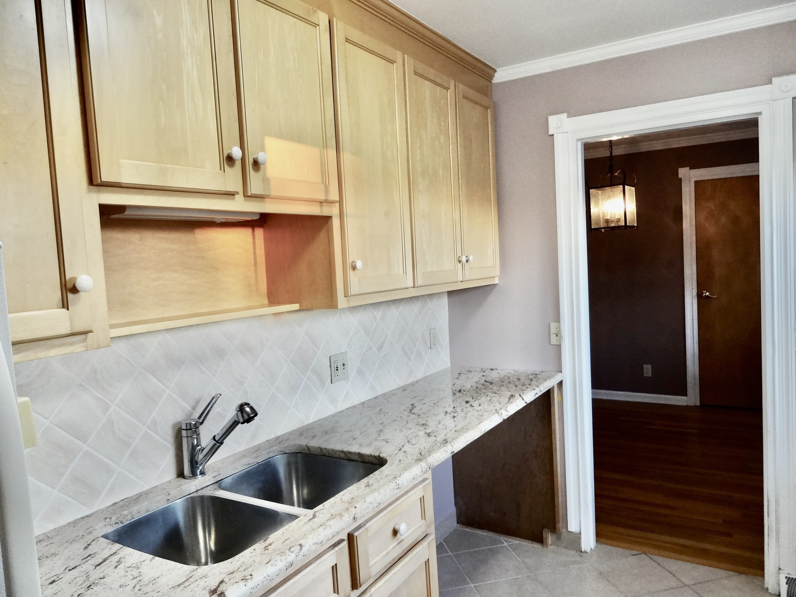 245 Unquowa Road, Unit 34 Fairfield, CT 06824 - Photo 9 of 24 a kitchen with granite countertop a sink and cabinets