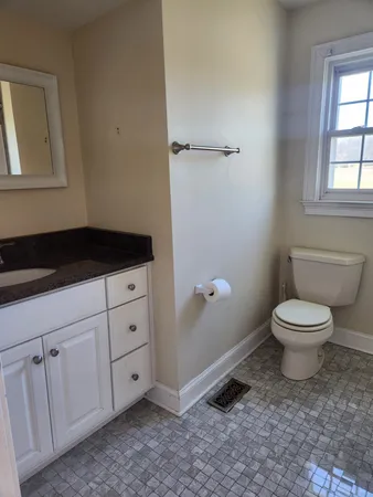 a white toilet sitting next to a bathroom sink