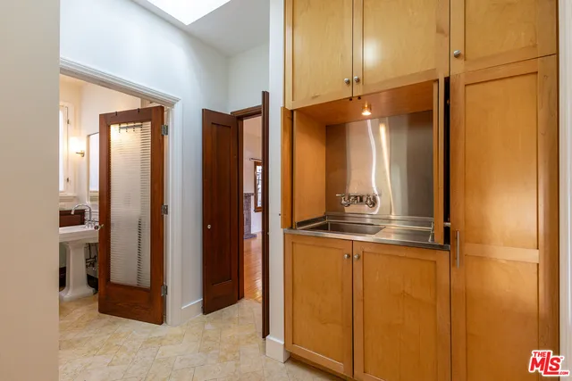 a view of empty room with fireplace and wooden floor