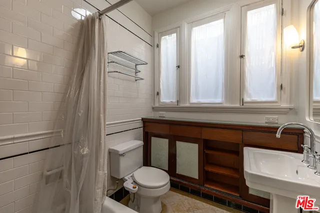 a view of a hallway with a view of bedroom with bathroom