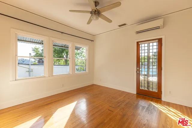 a view of empty room with wooden floor