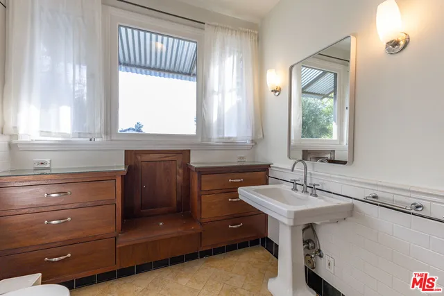a view of a patio with a table and chairs and potted plants