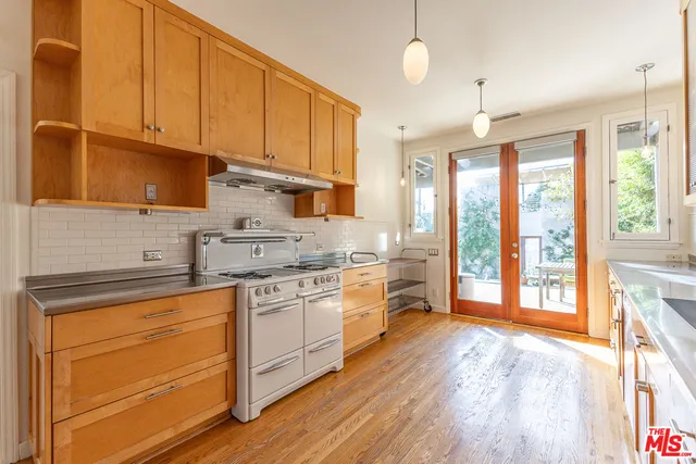 a kitchen with granite countertop a sink and cabinets