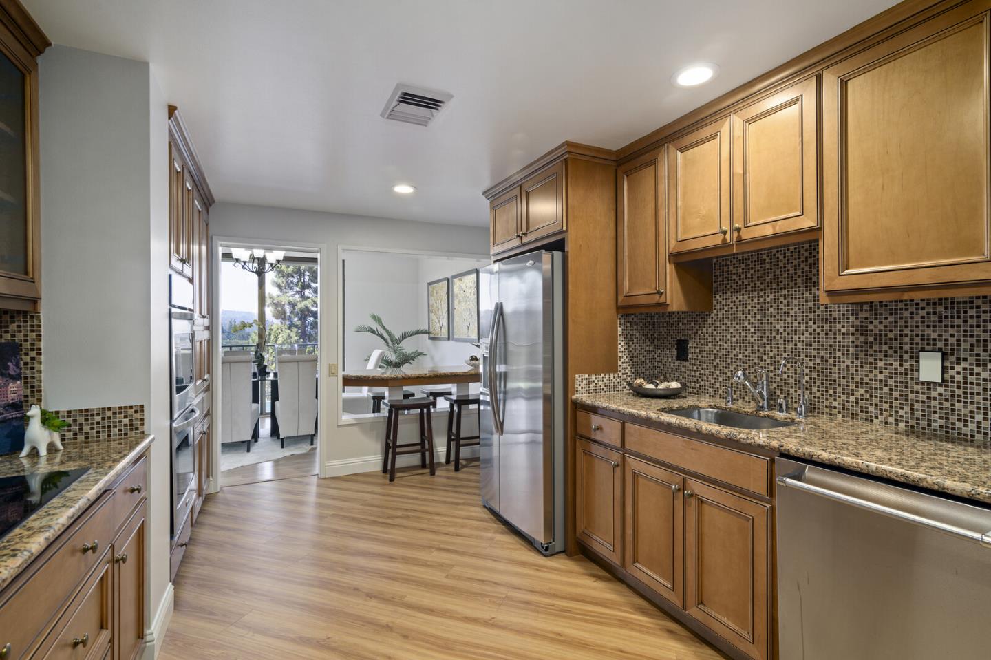 50 Mounds Road, Unit 415 San Mateo, CA 94402 - Photo 11 of 29 a kitchen with stainless steel appliances granite countertop sink stove top oven and cabinets