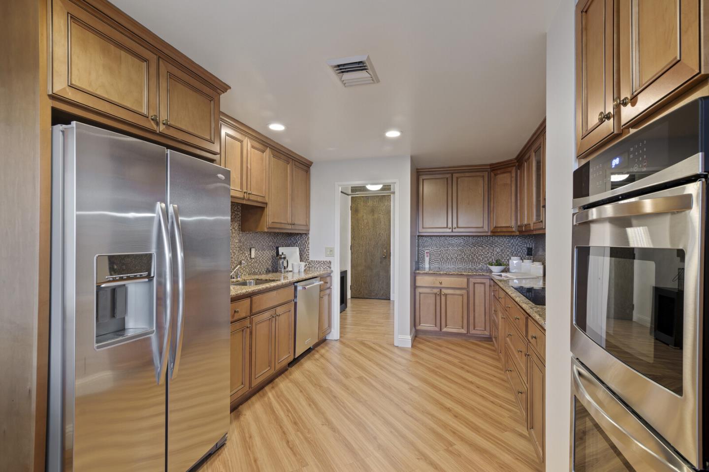 50 Mounds Road, Unit 415 San Mateo, CA 94402 - Photo 12 of 29 a kitchen with stainless steel appliances granite countertop a refrigerator a stove and a sink