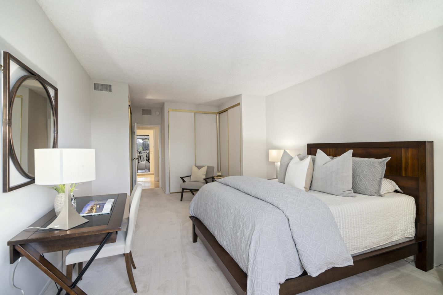 50 Mounds Road, Unit 415 San Mateo, CA 94402 - Photo 21 of 29 a bedroom with a bed a mirror and lamp