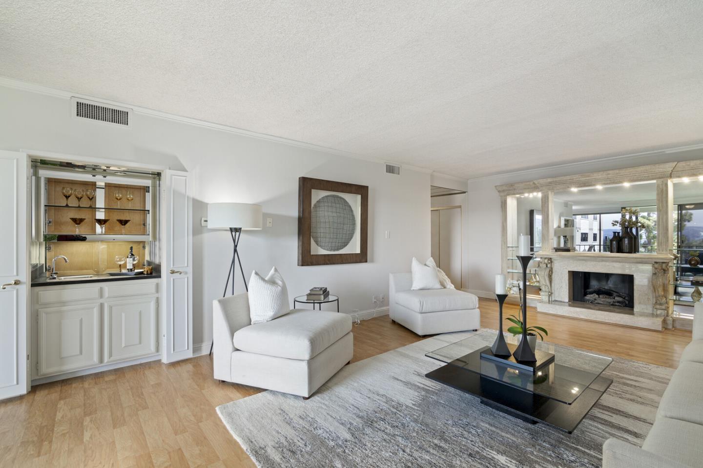 50 Mounds Road, Unit 415 San Mateo, CA 94402 - Photo 5 of 29 a living room with furniture a fireplace and flat screen tv