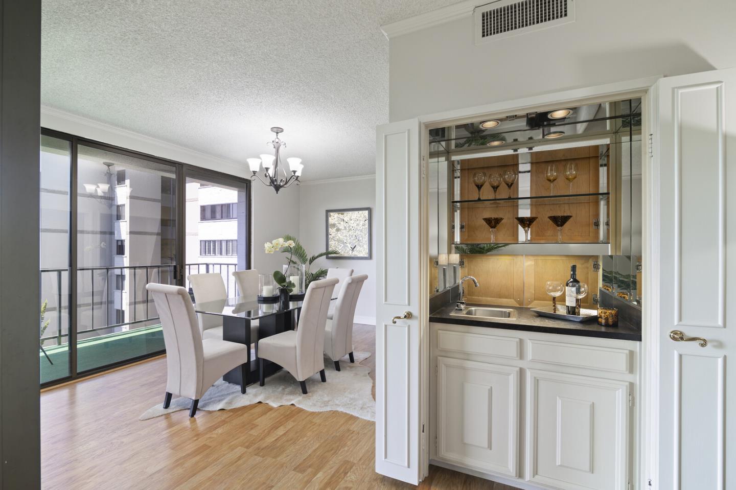 50 Mounds Road, Unit 415 San Mateo, CA 94402 - Photo 7 of 29 a dining room with wooden floor and a chandelier
