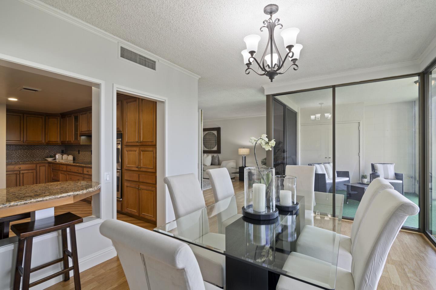 50 Mounds Road, Unit 415 San Mateo, CA 94402 - Photo 8 of 29 a view of a dining room with furniture a chandelier and wooden floor