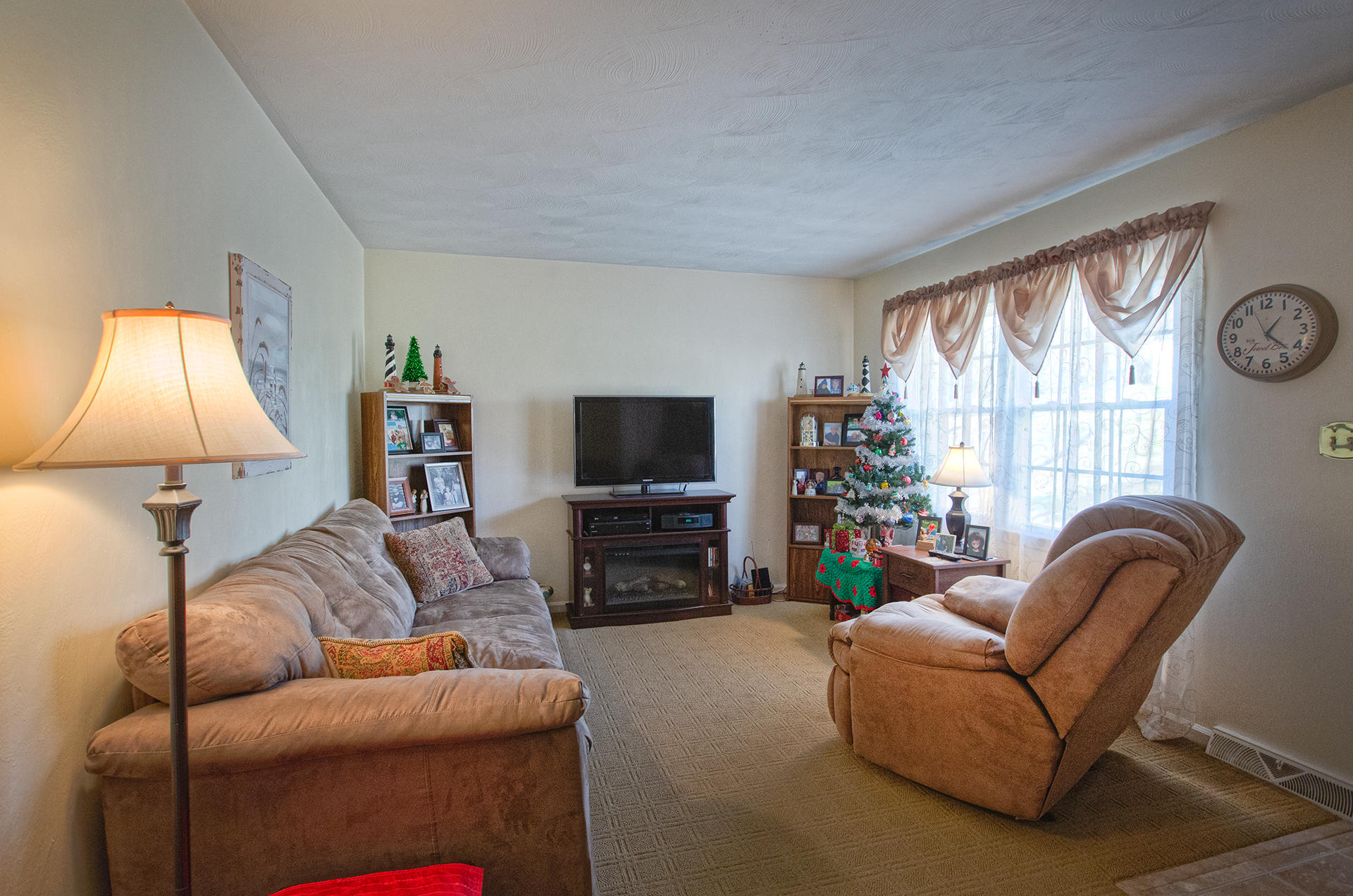 2015 Kiska Road Salem, VA 24153 - Photo 3 of 25 a living room with furniture a flat screen tv and a large window