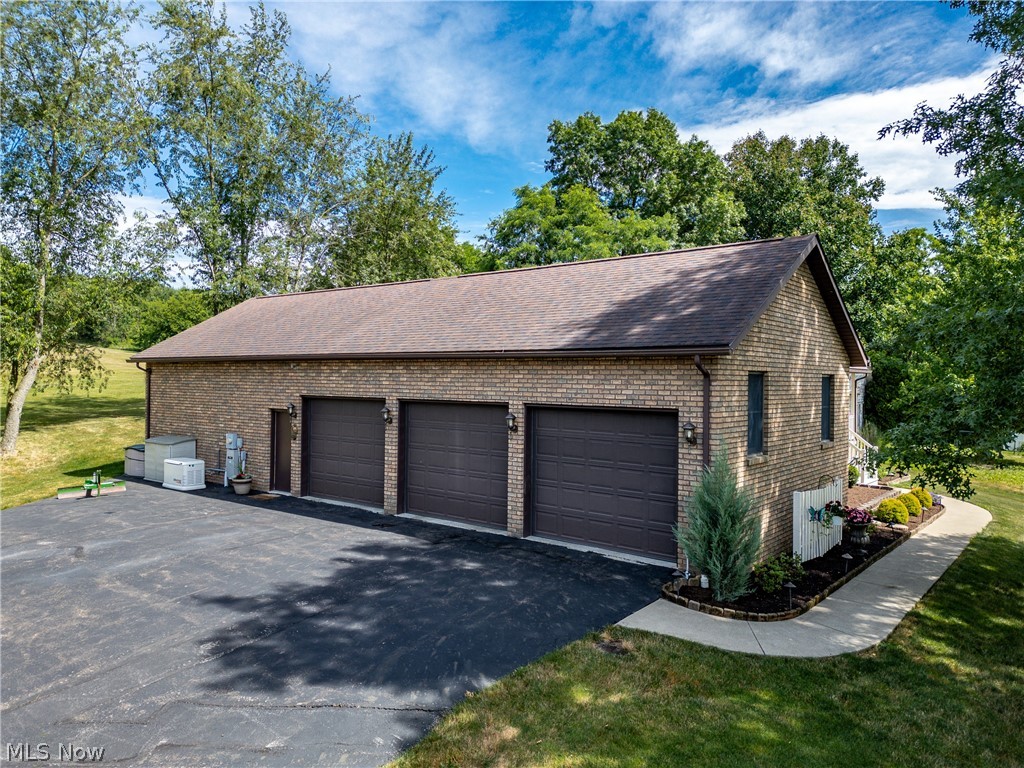 20 Reedsburg Road Wooster, OH 44691 - Photo 4 of 42 Garage featuring a yard