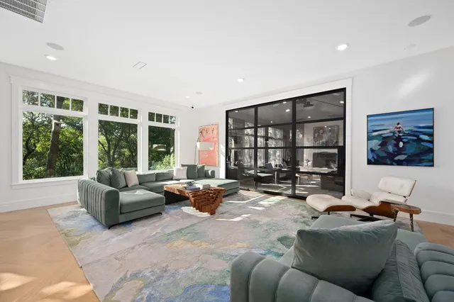 a living room with furniture and large windows