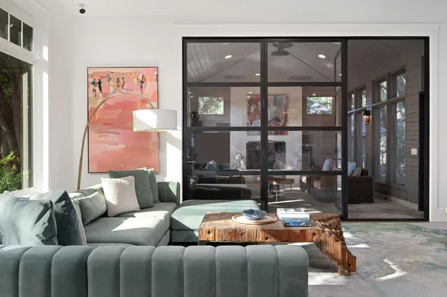 a living room with furniture and large window