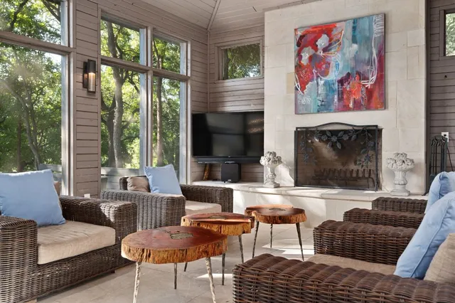 a living room with furniture and large windows