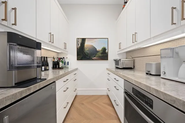 a view of a livingroom with furniture and a potted plant