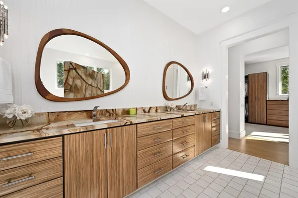 a bathroom with a toilet a sink and a mirror