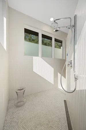 a kitchen with a sink a stove and white cabinets