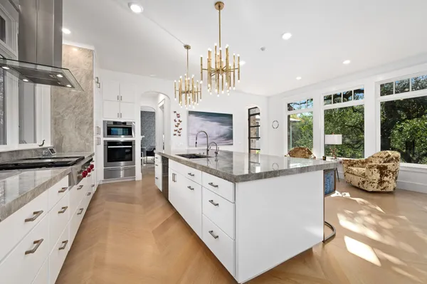 a kitchen with stainless steel appliances granite countertop a stove and cabinets