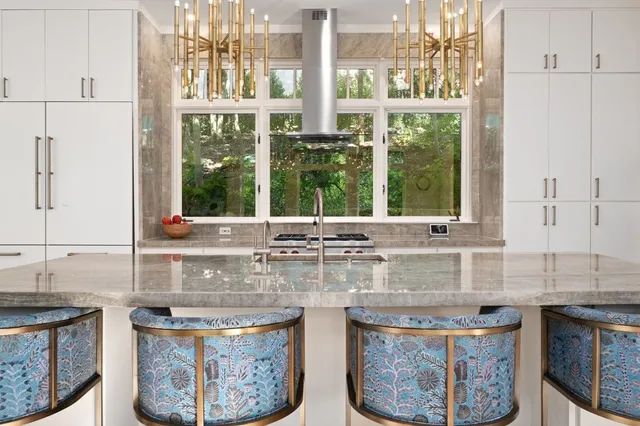 a kitchen with stainless steel appliances granite countertop a stove a sink and a refrigerator