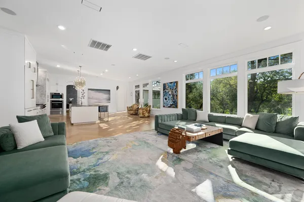 a living room with furniture and large window