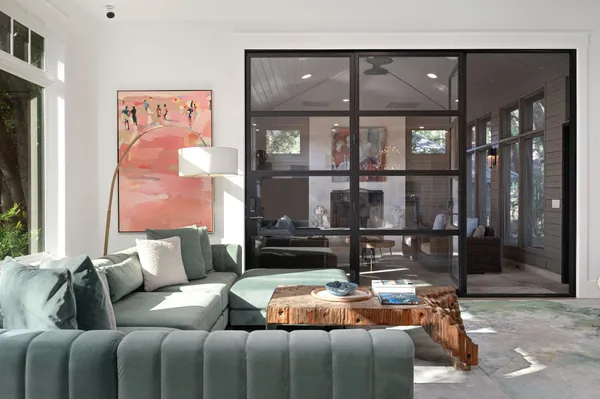 a living room with furniture large window and a flat screen tv