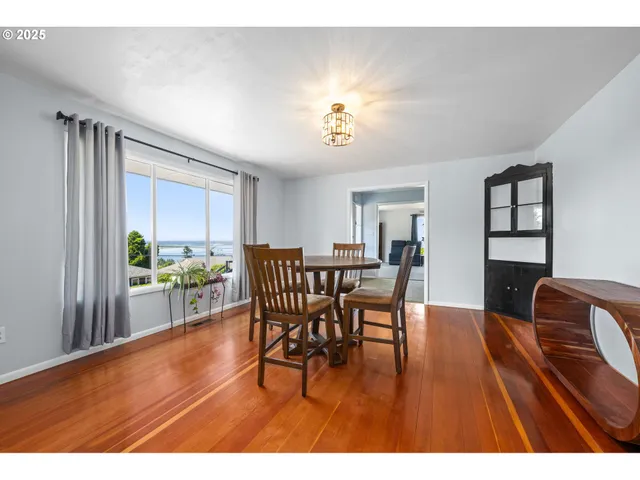 a kitchen with wooden floors and refrigerator